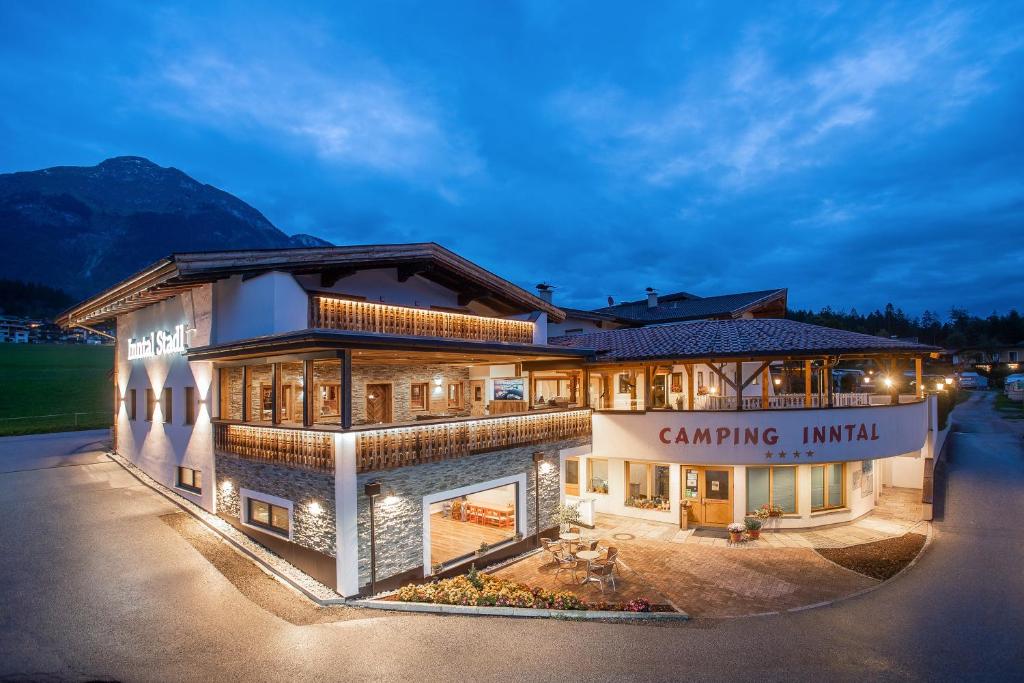 a large building with a camping institute sign in front of it at Camping Inntal in Wiesing