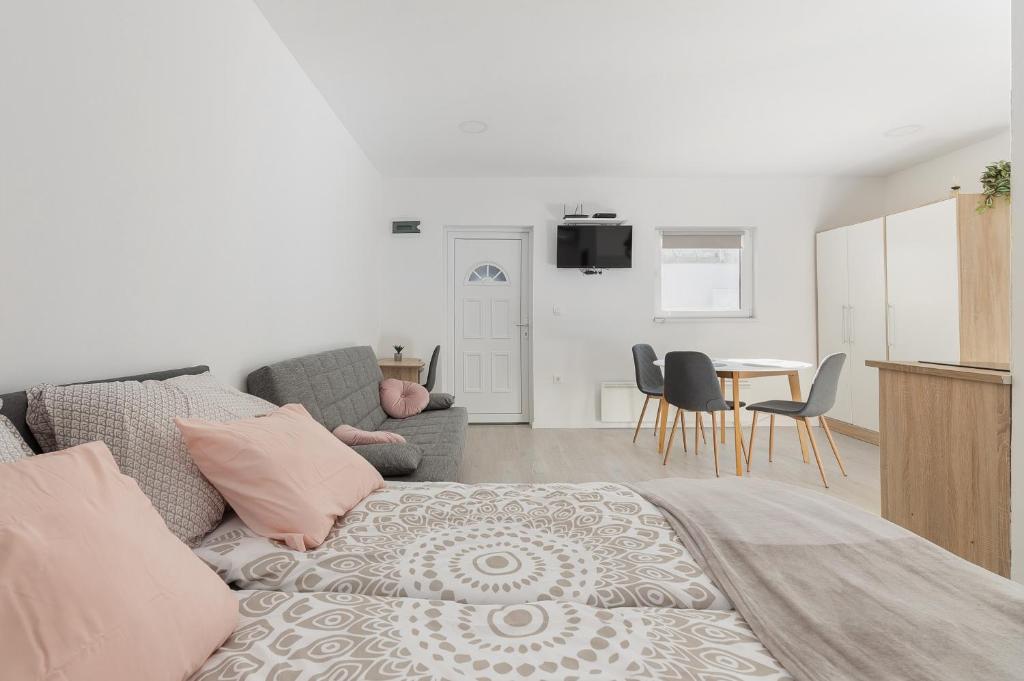 a living room with a couch and a table with chairs at Apartments Berni in Ljubljana