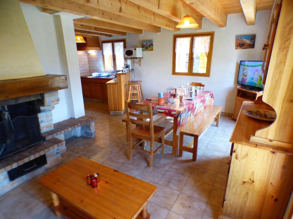 a living room with a table and a fireplace at Chalet Les Saisies, 4 pièces, 8 personnes - FR-1-594-42 in Hauteluce