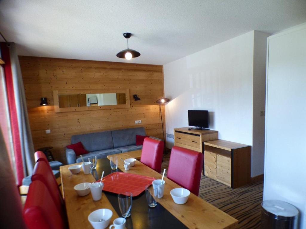 a living room with a table and red chairs at Appartement Les Saisies, 3 pièces, 8 personnes - FR-1-594-71 in Hauteluce