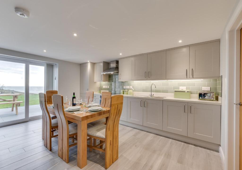 a kitchen with a table and chairs and a dining room at Ty Mawr in Aberdaron