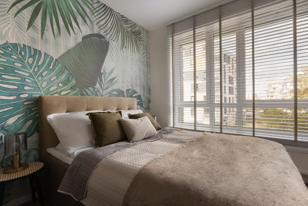 Posteľ alebo postele v izbe v ubytovaní Glow Apartments, Gdańsk Śląska 12