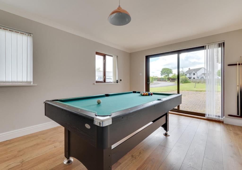 a room with a pool table in a house at Salem in Cross Inn
