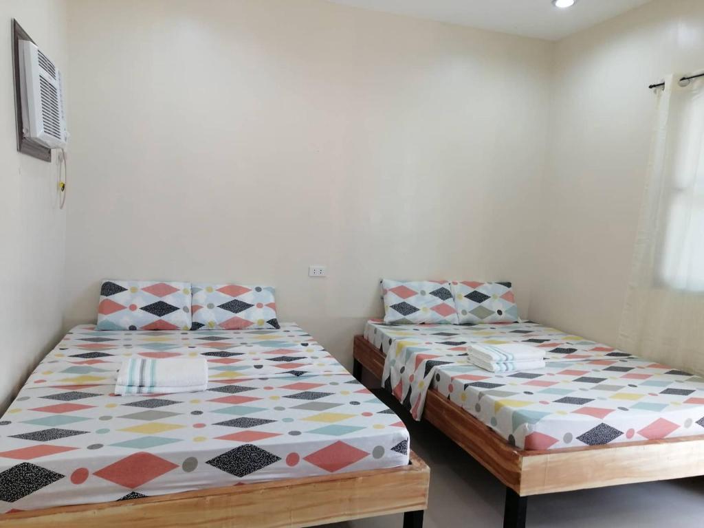 Postel nebo postele na pokoji v ubytování Chef Panyang Beach Resort Okoy