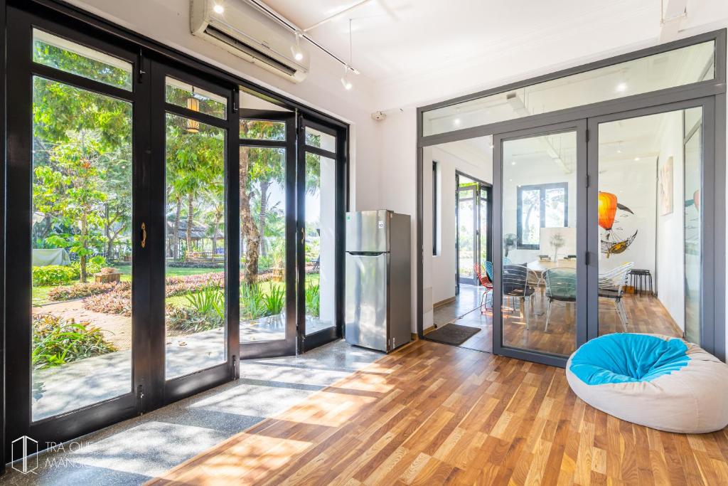 an open living room with sliding glass doors at Tra Que Mansion in Hoi An