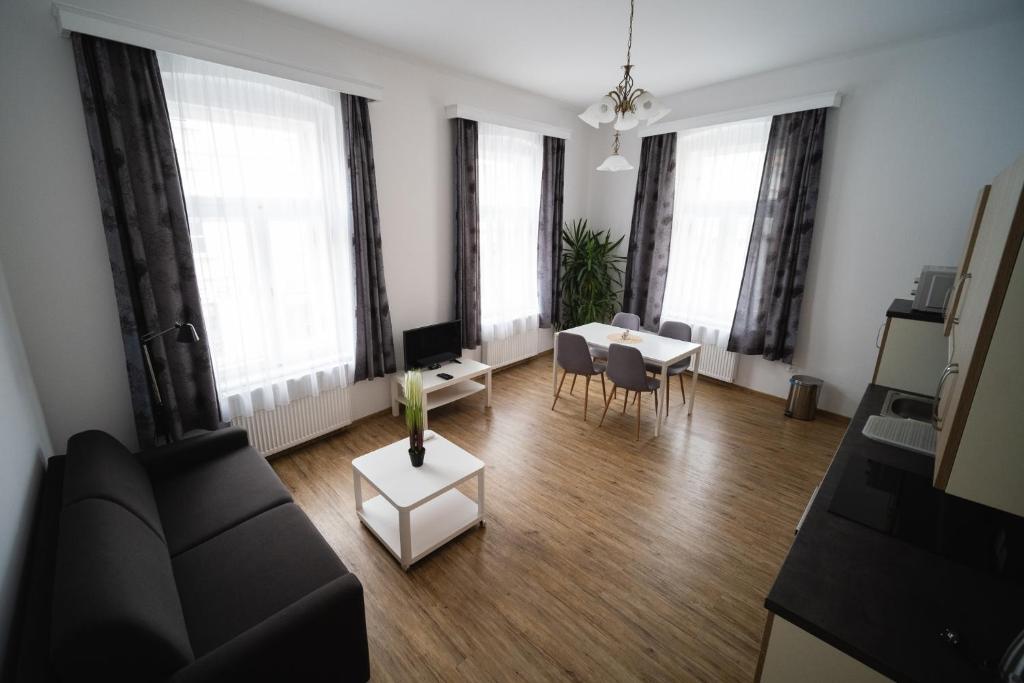 a living room with a couch and a table at Apartmany 21 Třeboň in Třeboň