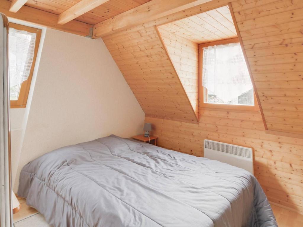 a bedroom with a bed in a room with two windows at Maison Luz-Saint-Sauveur, 3 pièces, 4 personnes - FR-1-402-40 in Luz-Saint-Sauveur