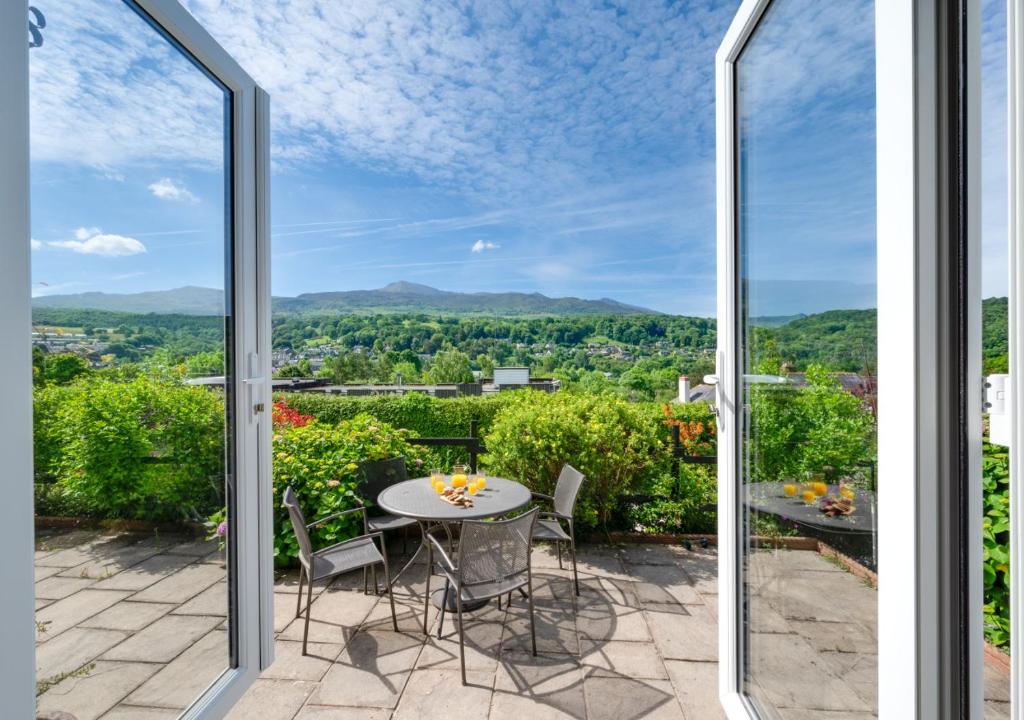 a view from the balcony of a house with a table and chairs at Llety Heulog in Dolgellau