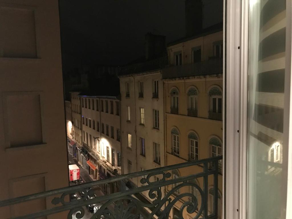 a view of a city at night from a balcony at joli appart au centre de Lyon in Lyon