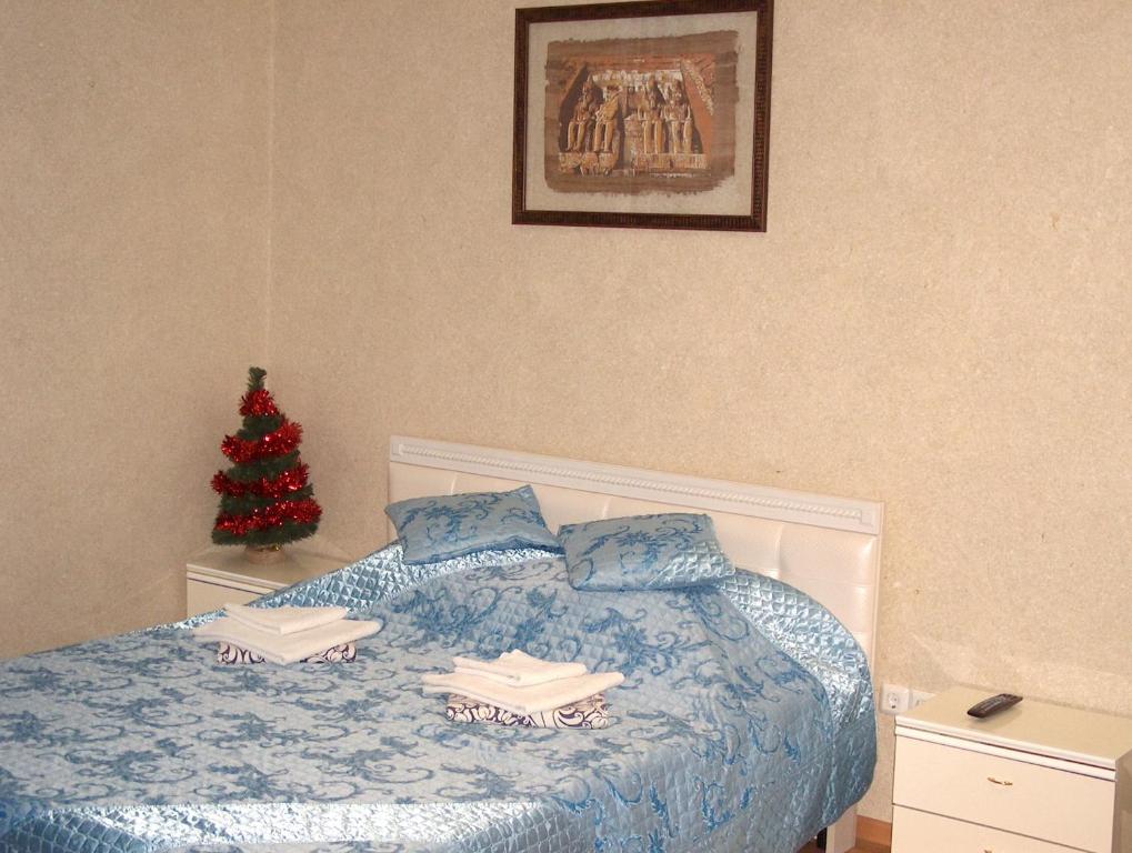 a bedroom with a christmas tree and a bed at Hotel Four Rooms on Energetikov in Tyumen