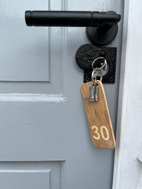 a padlock on a door with the number on it at Lime Tree Cottage in Tillingham