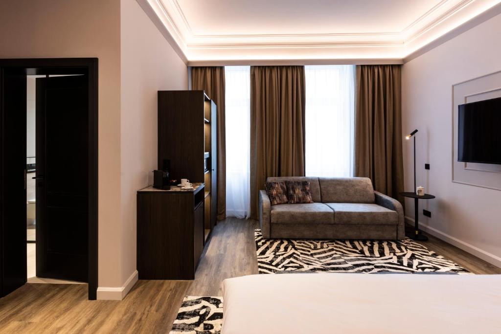 a living room with a couch and a chair at O11 Boutique Hotel Vienna in Vienna