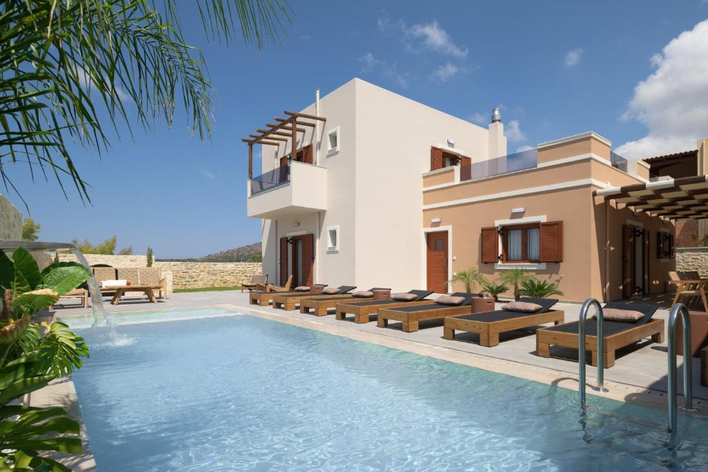 een villa met een zwembad en een huis bij Jasmine Villa, with curated design, By ThinkVilla in Perama