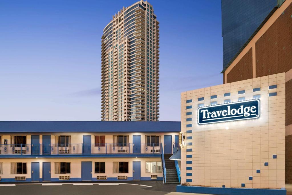 a building with a sign on it with a skyscraper at Travelodge by Wyndham Las Vegas in Las Vegas