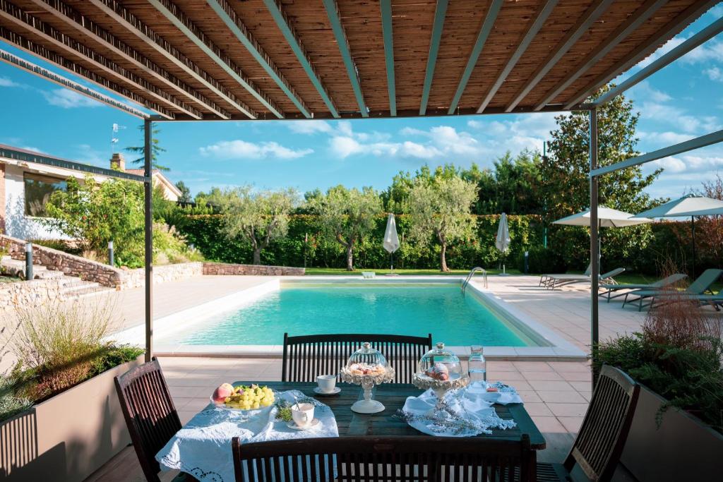 a patio with a table and a swimming pool at B&B La Ferula in Altamura