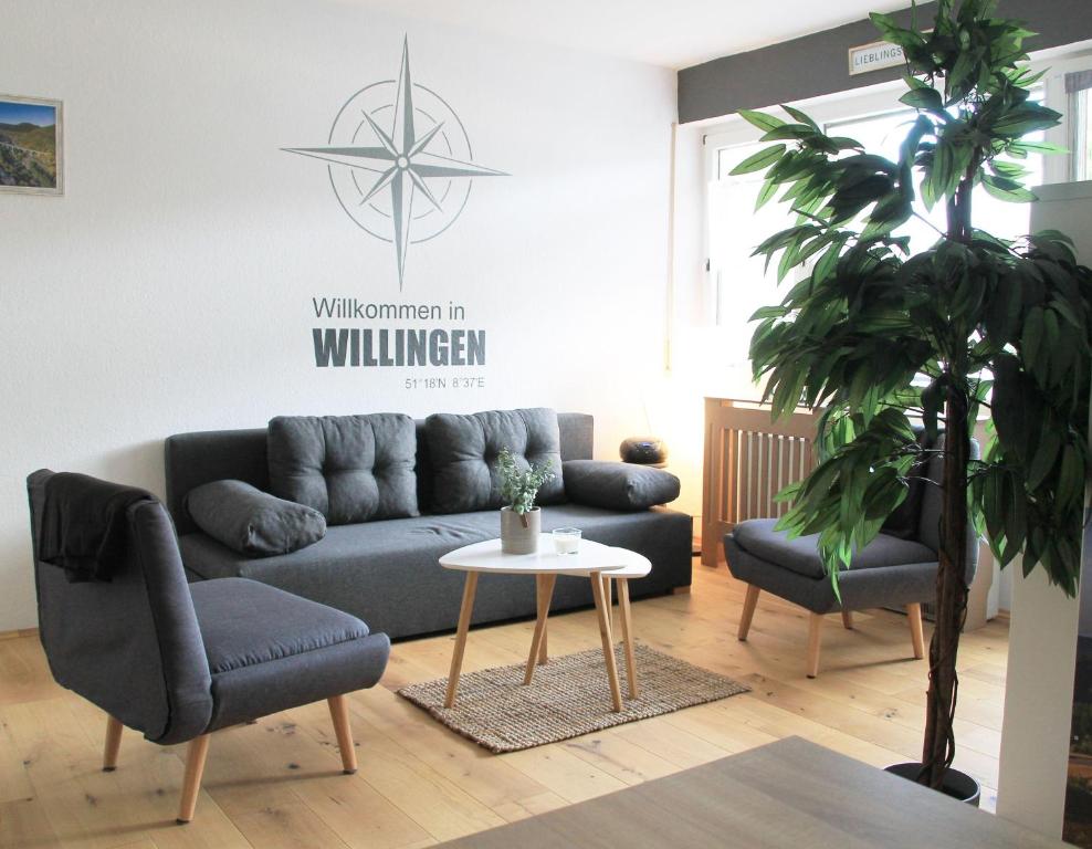 a living room with a couch and two chairs and a table at Ferienwohnung-Sonnenblick-Willingen in Willingen