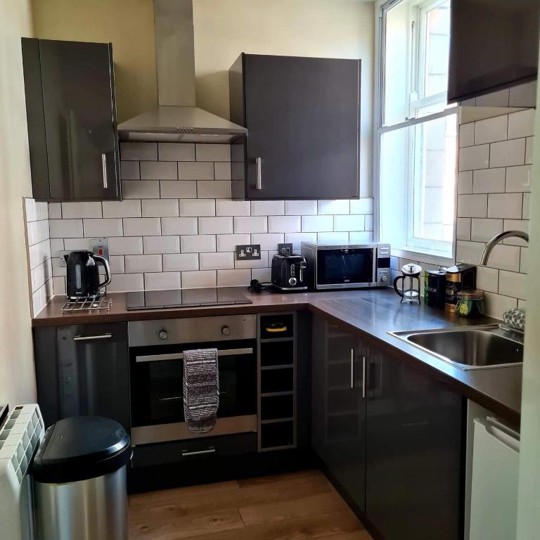 Kuchyň nebo kuchyňský kout v ubytování Coppergate Apartments