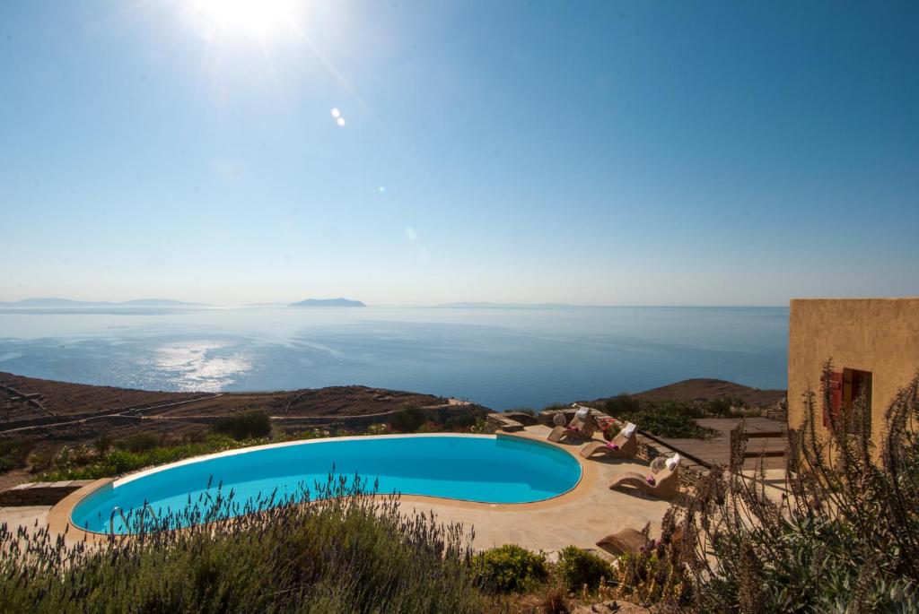a swimming pool with the ocean in the background at Als Marmarei in Ioulis