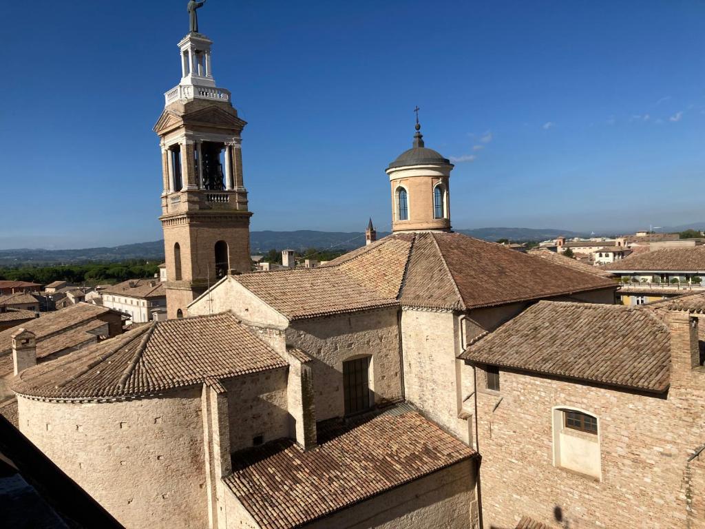 an old building with two towers on top of it at Affittacamere La Terrazza Sul Campanile in Foligno