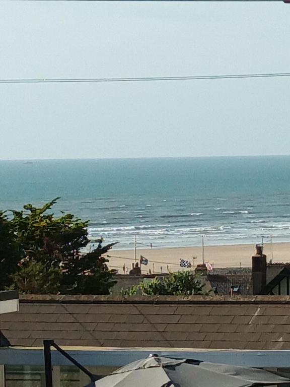 a view of the beach from the balcony of a condo at Contemporary one bed studio. Sea views and parking in Westward Ho