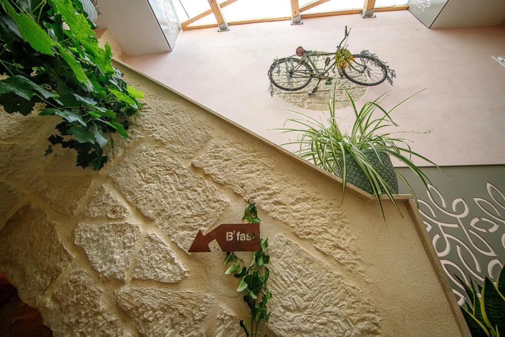 a bike parked next to a wall with a sign at The Heritage Boutique Accommodation in Rabat