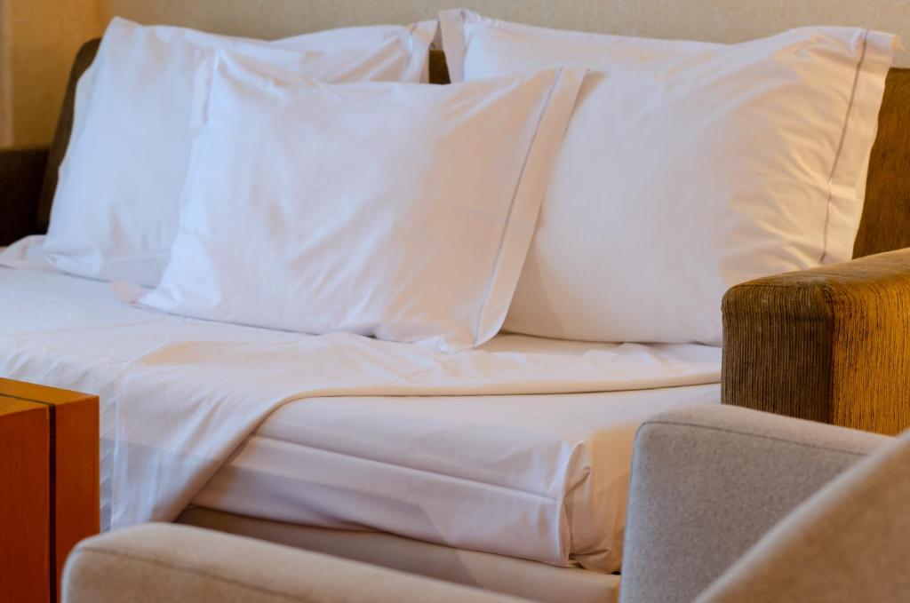 Uma cama ou camas num quarto em Hotel Roma