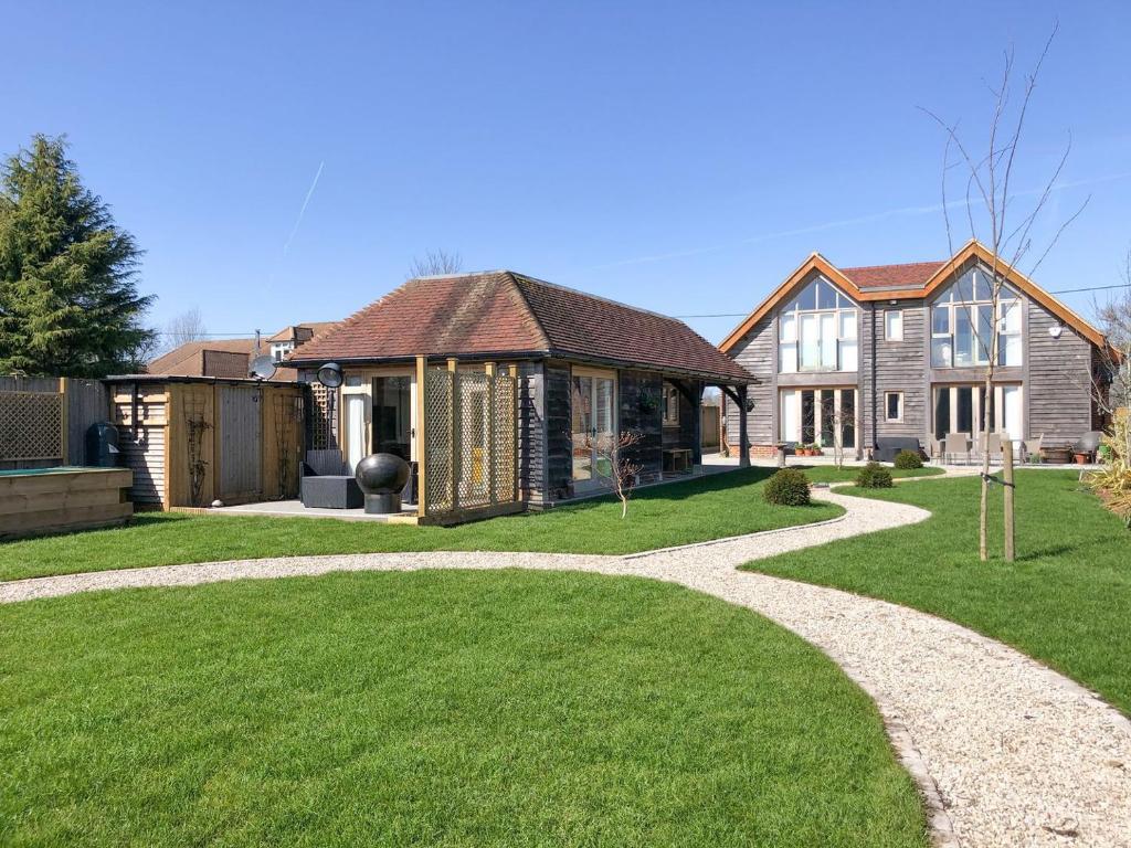 a house with a garden and a walkway at Elm Retreat in Upper Hardres