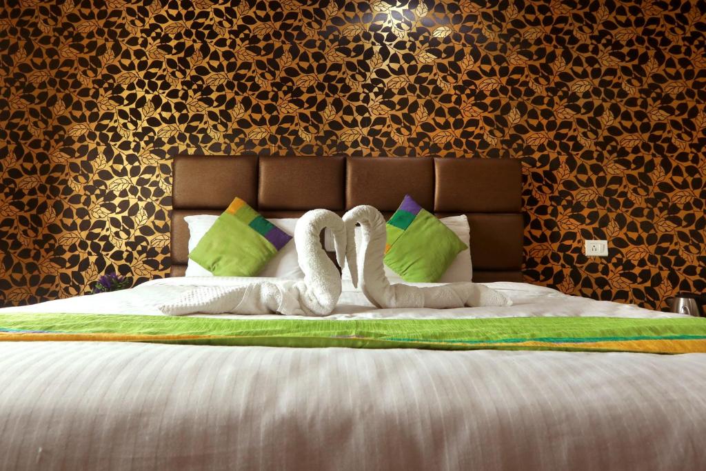 Postel nebo postele na pokoji v ubytování Sekaran Hotel OMR