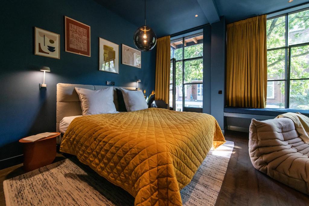 a bedroom with a large bed with a yellow blanket at Luxurious Residence in Vondelpark/Museum District in Amsterdam