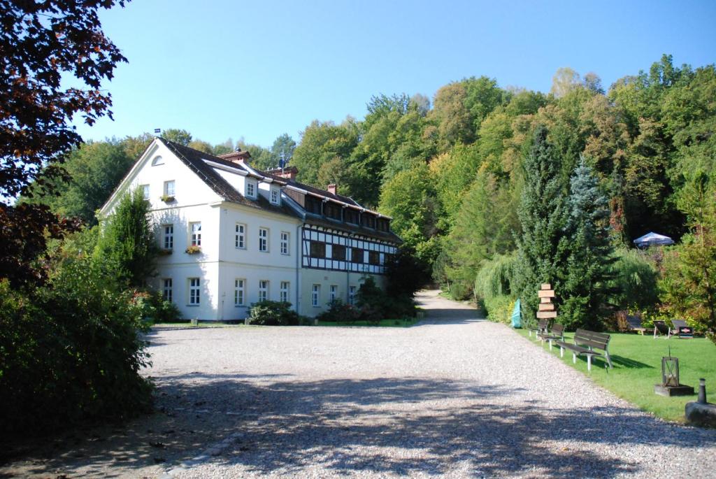 a large white building on a hill with trees at Klekotki Spa & Resort in Klekotki