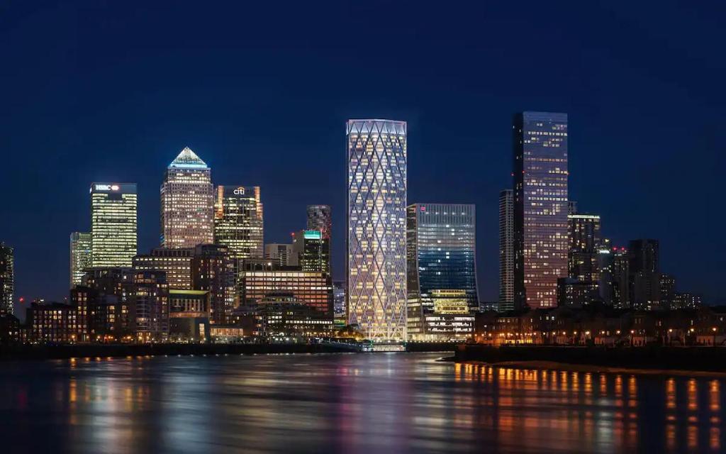 a nighttime view of a city skyline with lights at City Riverview 1/2 Bedroom Apartment in London