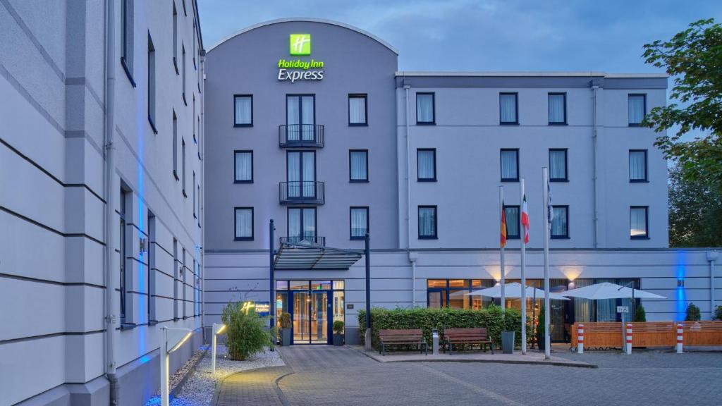 a large white building with a sign on it at Holiday Inn Express Dortmund by IHG in Dortmund