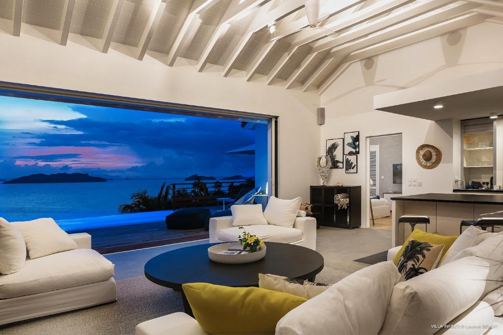 a living room with a view of the ocean at Infiniti Entire Luxury Villa Breath Taking View in St Barth in Pointe Milou