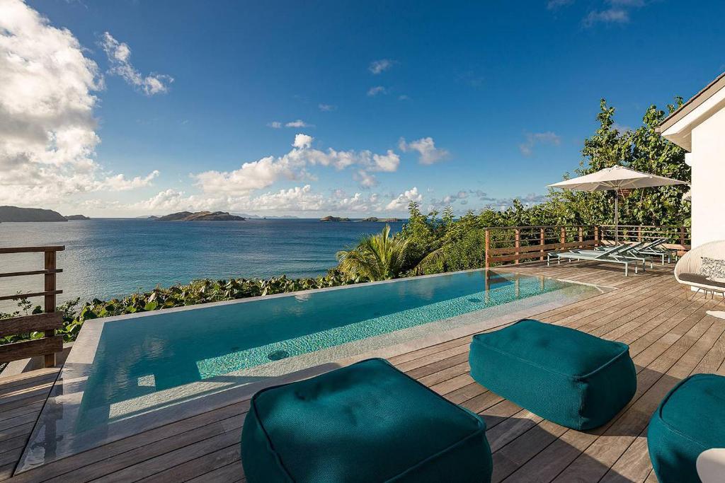 a swimming pool with a view of the ocean at Infiniti Entire Luxury Villa Breath Taking View in St Barth in Pointe Milou