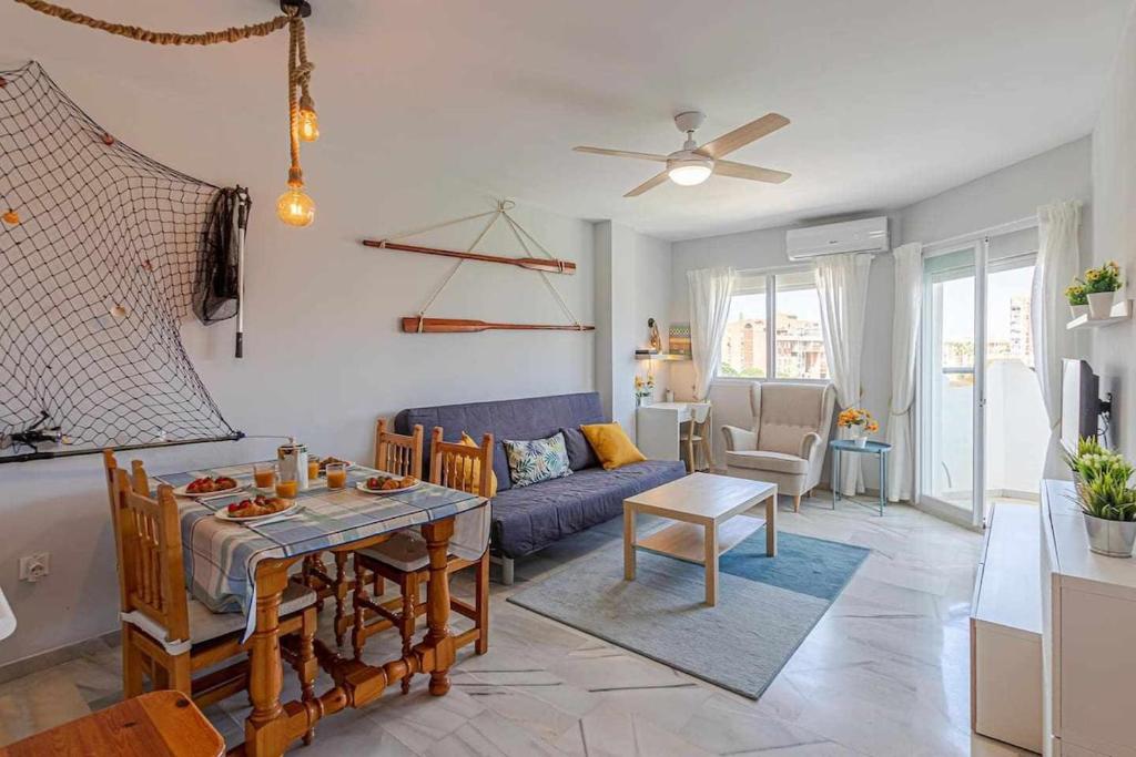 a living room with a blue couch and a table at 797 Holiday Rentals - Luminoso piso para 4 en Arroyo de la miel in Arroyo de la Miel