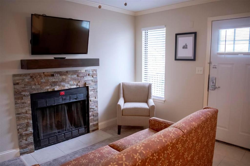 a living room with a couch and a fireplace at Annabell Gardens in Lincoln