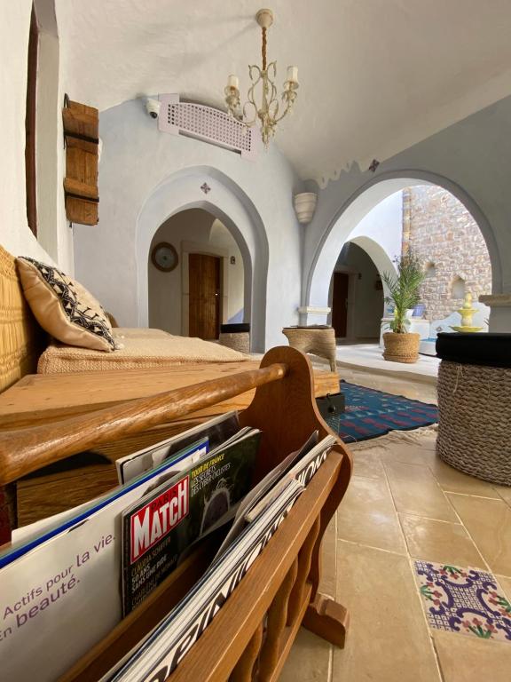 a bedroom with a bed and a chandelier at Hôtel Djerba Authentique - Au centre de Midoun in Midoun