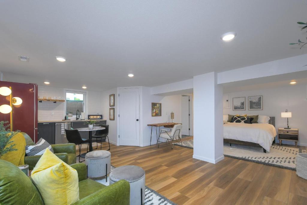a large living room with a bed and a living room at Bright & Modern Basement Apartment Dt N'hood in Vancouver