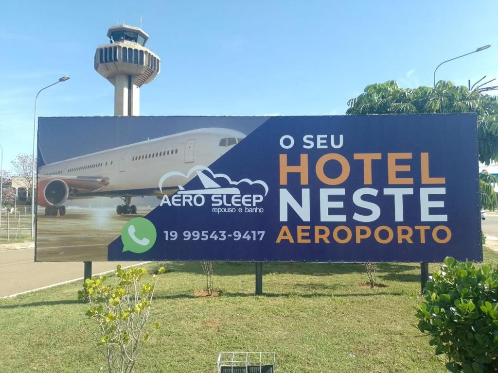 a sign for a hotel next to an airplane at Hotel Aero Sleep Campinas in Campinas