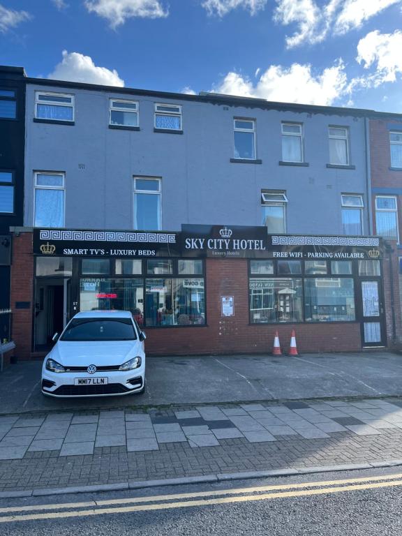 a white car parked in front of a building at Sky city hotel in Blackpool