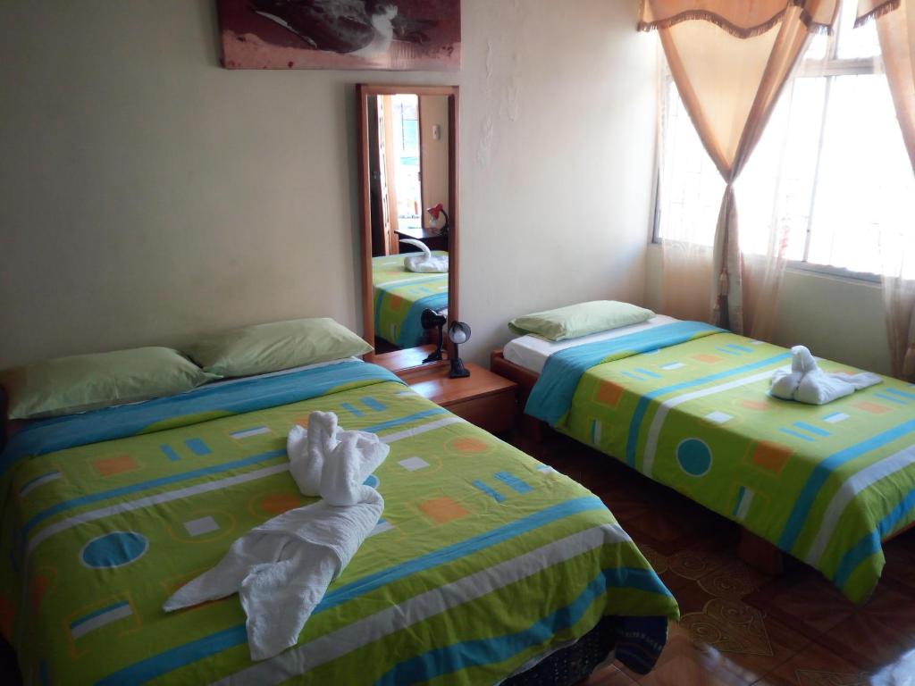 Postel nebo postele na pokoji v ubytování Hostal Miconia