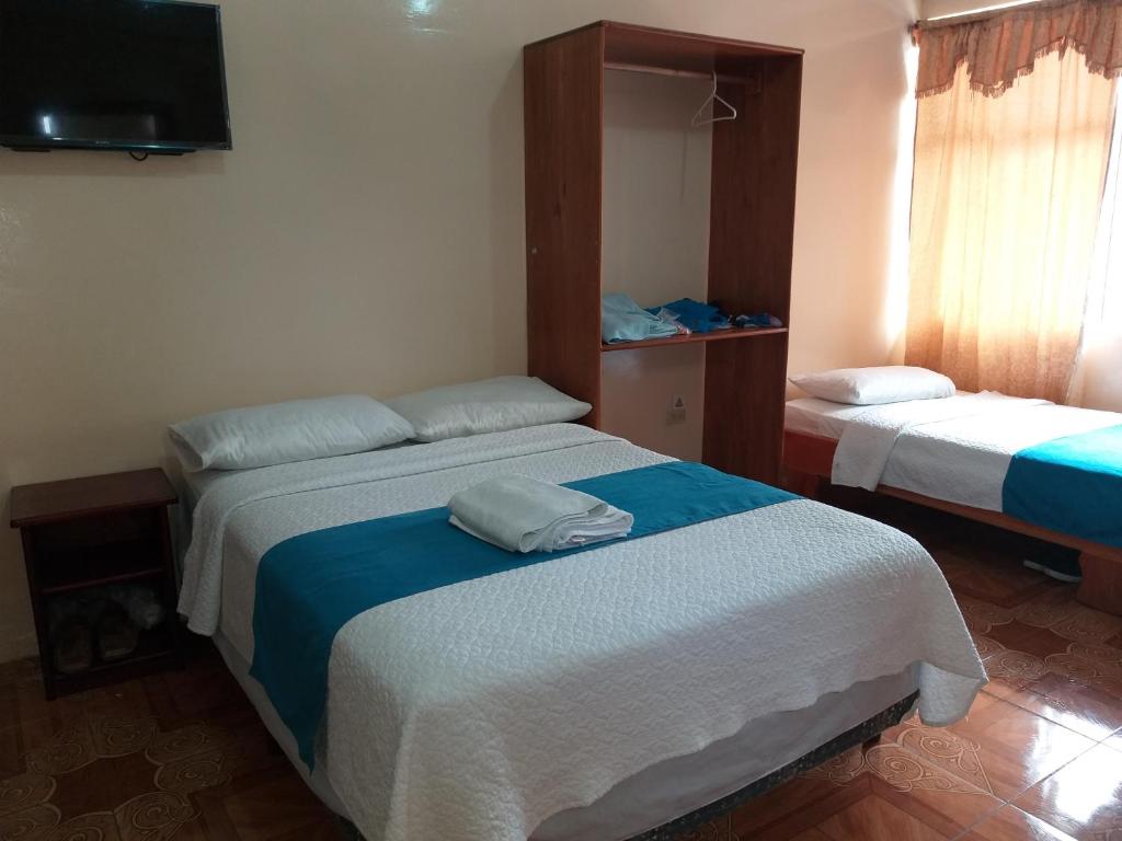 Postel nebo postele na pokoji v ubytování Hostal Miconia