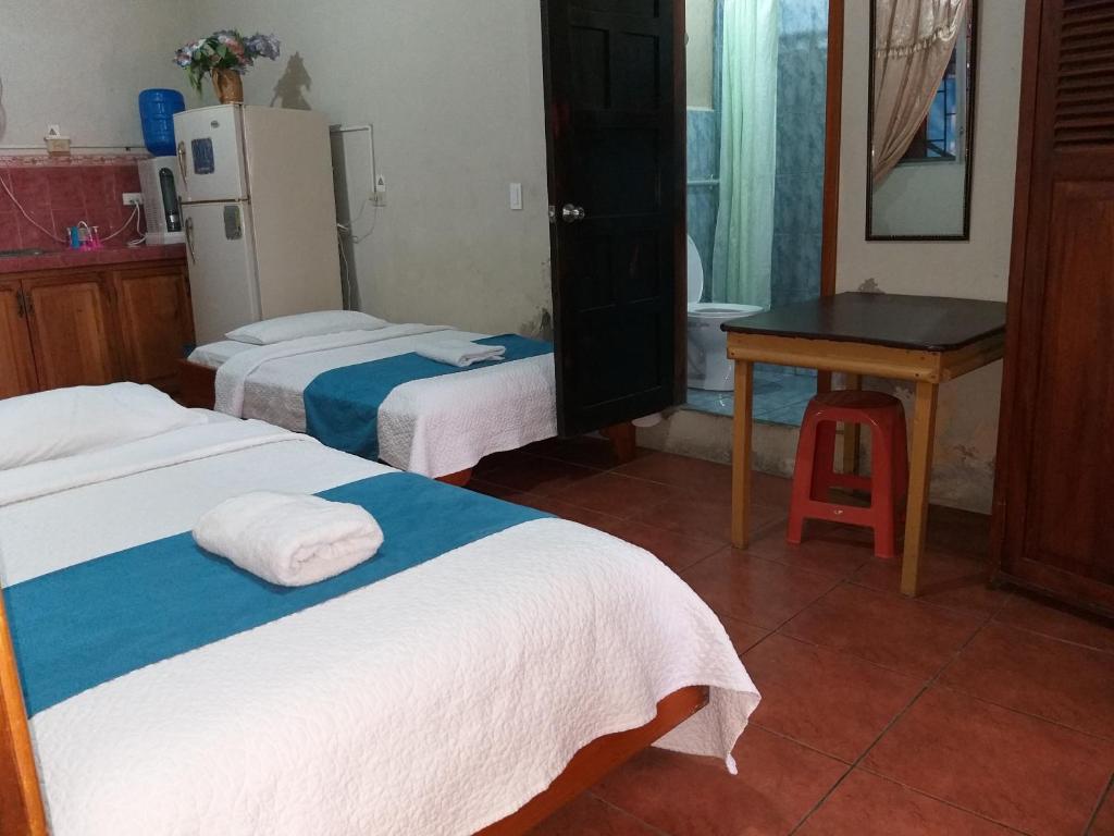Postel nebo postele na pokoji v ubytování Hostal Miconia