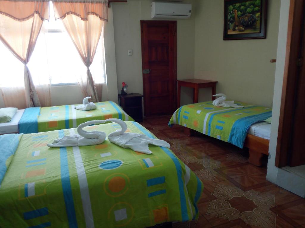 Postel nebo postele na pokoji v ubytování Hostal Miconia