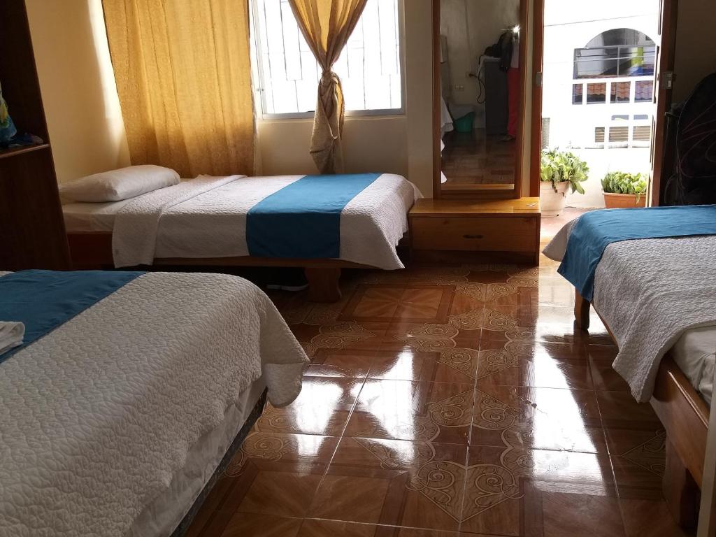 Postel nebo postele na pokoji v ubytování Hostal Miconia