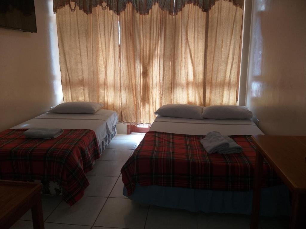 Postel nebo postele na pokoji v ubytování Hostal Miconia