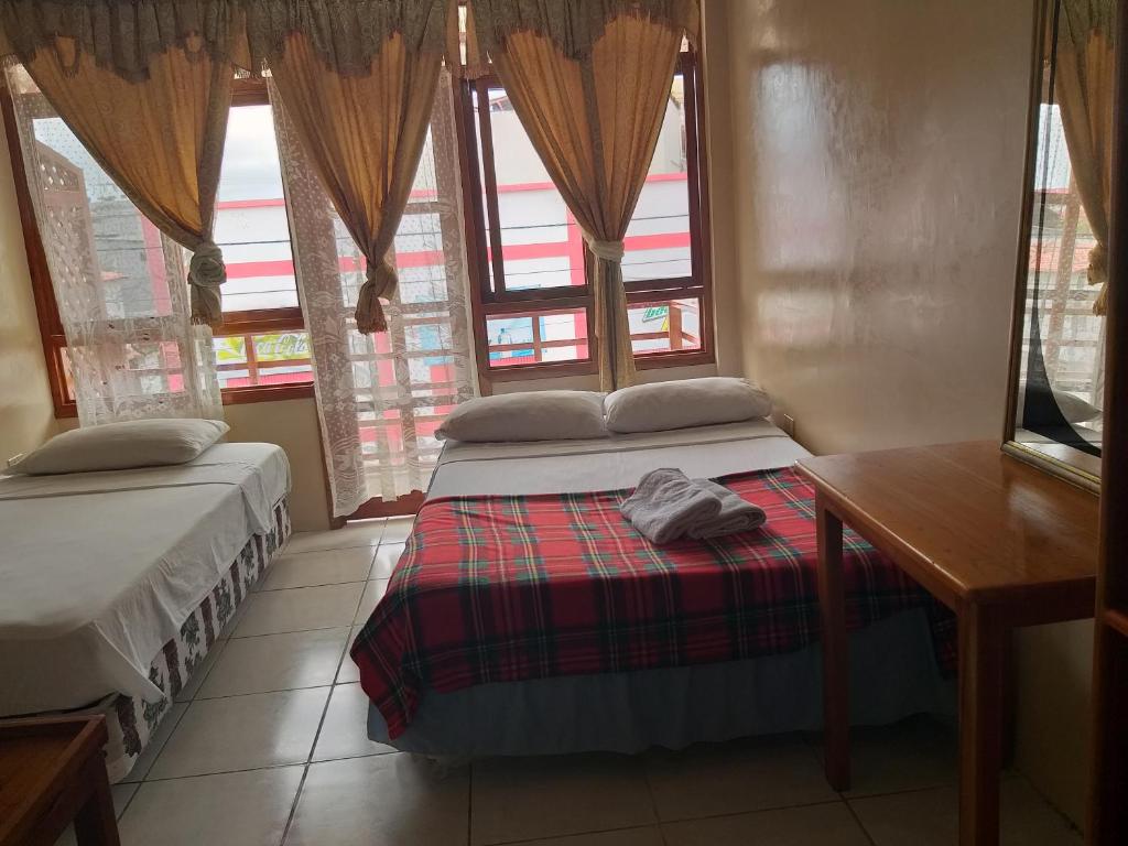 Postel nebo postele na pokoji v ubytování Hostal Miconia