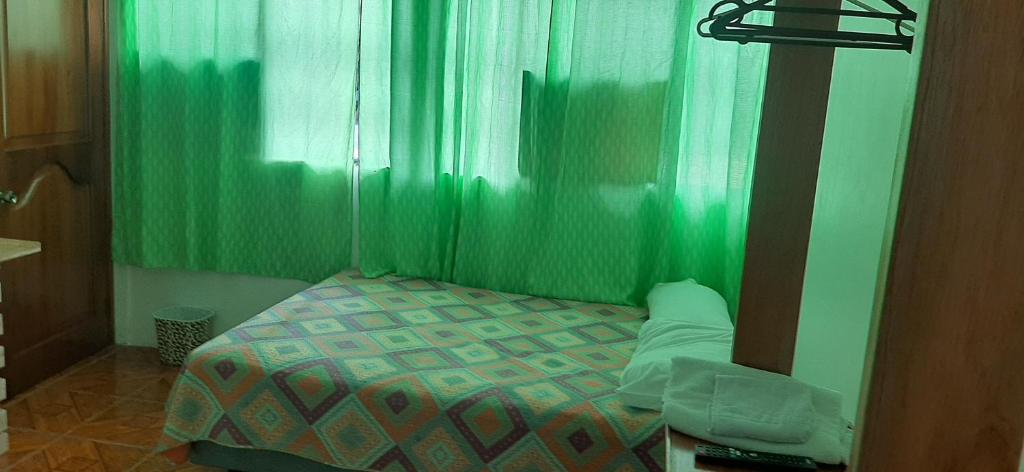 Postel nebo postele na pokoji v ubytování Hostal Miconia
