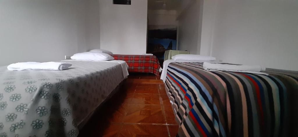 Postel nebo postele na pokoji v ubytování Hostal Miconia