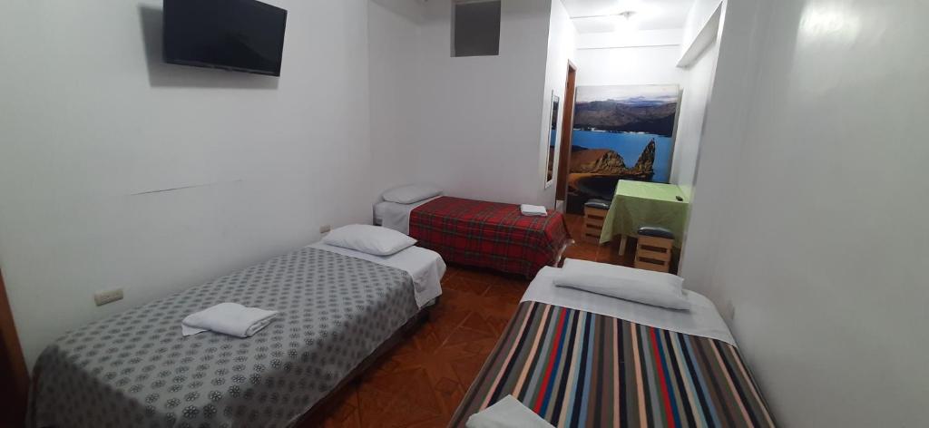 Postel nebo postele na pokoji v ubytování Hostal Miconia